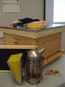 A sample hive, along with accessories needed to gather honey.